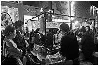 Busy food stall by night. Seoul, South Korea (black and white)