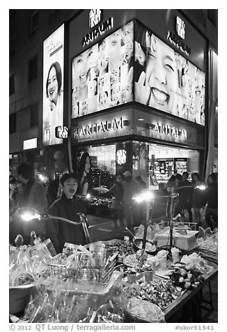 Street food vendor and cosmetics store by night. Seoul, South Korea (black and white)