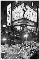 Street food vendor and cosmetics store by night. Seoul, South Korea (black and white)