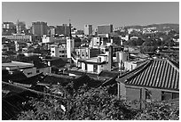 Hanok houses overlooking modern skyline. Seoul, South Korea (black and white)