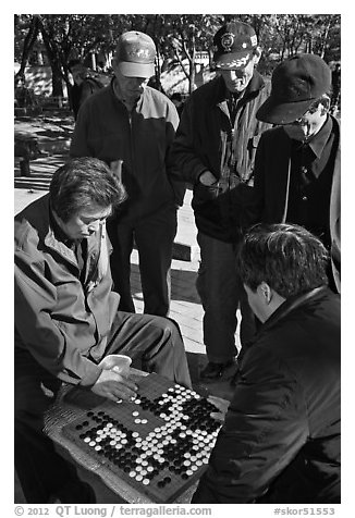 Elderly men play game of baduk (go). Seoul, South Korea (black and white)