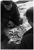 Pondering moves in go (baduk) game. Seoul, South Korea ( black and white)