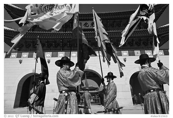 Guards carrying flags in front of main gate, Gyeongbokgung. Seoul, South Korea (black and white)