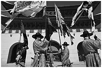 Guards carrying flags in front of main gate, Gyeongbokgung. Seoul, South Korea ( black and white)