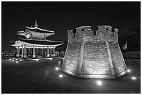 Crossbow tower and command post at night,  city lights, Suwon. South Korea (black and white)