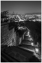 Path, wall, and city lights, Suwon Hwaseong Fortress. South Korea (black and white)