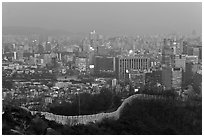 Old fortress wall and high-rises at dusk. Seoul, South Korea ( black and white)