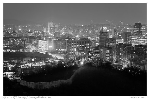 Old fortress wall and city skyline at night. Seoul, South Korea (black and white)