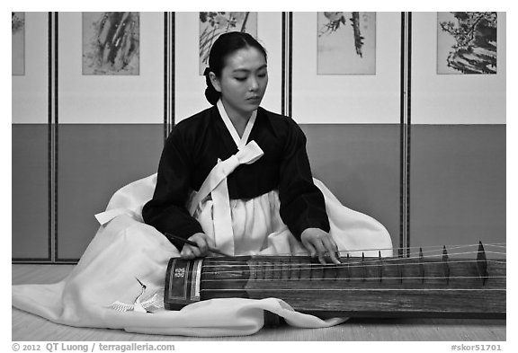 Woman playing traditional instrument. South Korea (black and white)