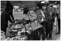 Hikers check out stand selling natural products. South Korea (black and white)