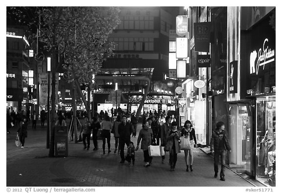 Shoppers strolling on pedestrian street at night. Daegu, South Korea (black and white)