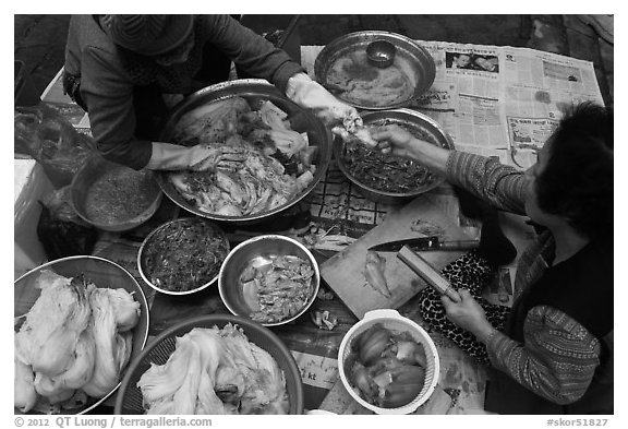 Passing along sample during kim chee preparation. Gyeongju, South Korea