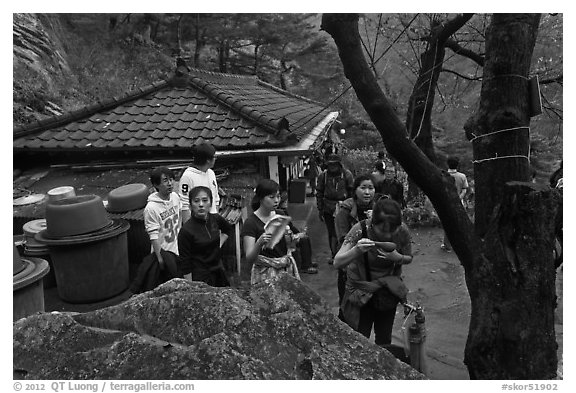 Hikers drinking from foundtain at Sangseonam hermitage, Namsan Mountain. Gyeongju, South Korea