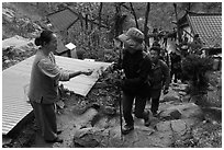 Woman giving sacred bread at Sangseonam hermitage, Namsan Mountain. Gyeongju, South Korea ( black and white)