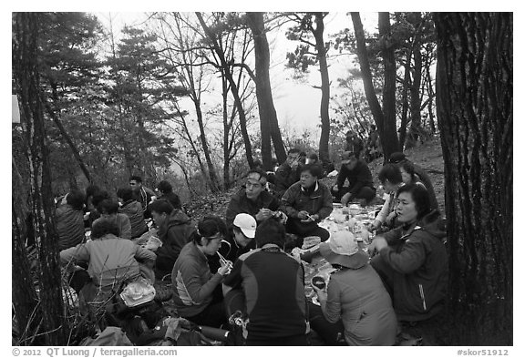 Large group of hikers eating on Geumobong Peak, Namsan Mountain. Gyeongju, South Korea