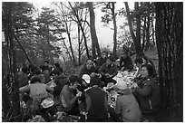 Large group of hikers eating on Geumobong Peak, Namsan Mountain. Gyeongju, South Korea (black and white)