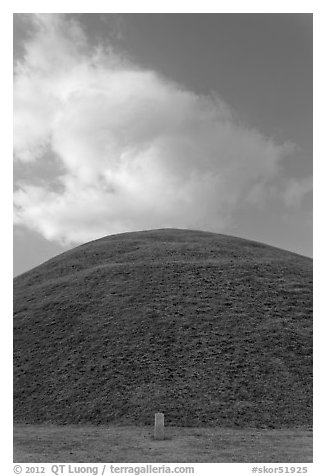 Mound of earth raised over grave and cloud. Gyeongju, South Korea (black and white)