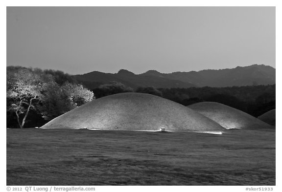 Illuminated tumuli at dusk and hills. Gyeongju, South Korea