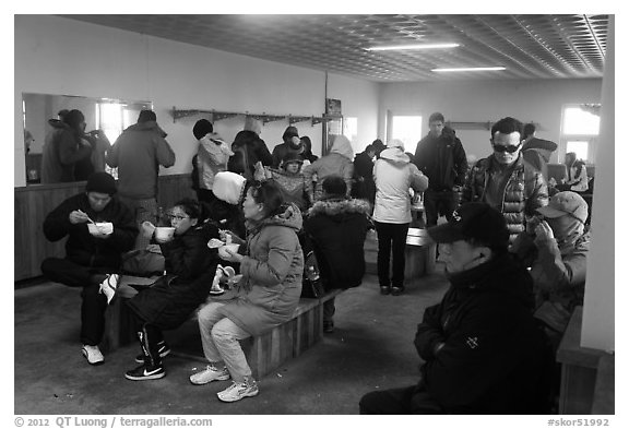 Hikers eating noodles inside Witseoreum shelter, Hallasan. Jeju Island, South Korea