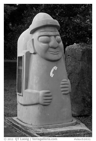 Telephone cabin shaped like Dolharubang. Jeju Island, South Korea (black and white)