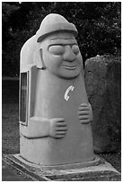 Telephone cabin shaped like Dolharubang. Jeju Island, South Korea (black and white)