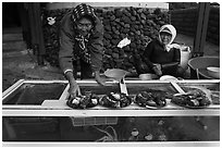 Haeneyo women selling seafood. Jeju Island, South Korea (black and white)