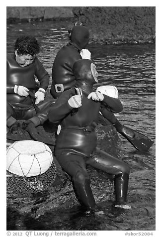 Haeneyo women arranging wetsuits. Jeju Island, South Korea (black and white)