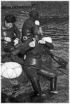 Haeneyo women arranging wetsuits. Jeju Island, South Korea ( black and white)