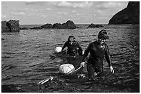 Haeneyo women walking out of water. Jeju Island, South Korea (black and white)