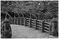 Footbridge and Dolharubang statues, Seogwipo. Jeju Island, South Korea ( black and white)