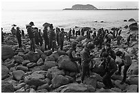 Tourists on rocky beach, Seogwipo. Jeju Island, South Korea ( black and white)