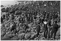 Crowd on rocky beach, Seogwipo. Jeju Island, South Korea ( black and white)