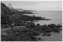 Tourists at Yongduam Rock, Jeju-si. Jeju Island, South Korea ( black and white)