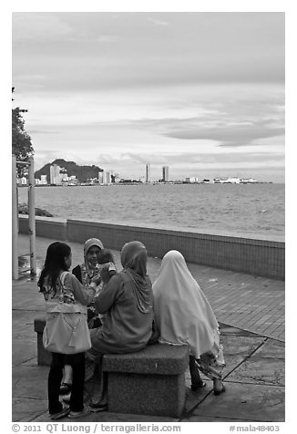 Women on waterfront. George Town, Penang, Malaysia