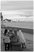 Women on waterfront. George Town, Penang, Malaysia (black and white)