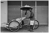 Driver and trishaw. George Town, Penang, Malaysia (black and white)