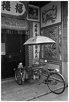 Bicycle rickshaw at temple entrance. George Town, Penang, Malaysia ( black and white)