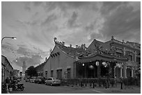 Temple and distant minaret at sunset. George Town, Penang, Malaysia ( black and white)