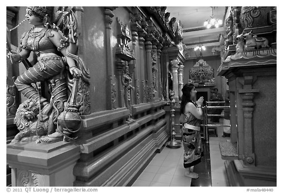 Woman worshipping at Sri Mariamman Temple. George Town, Penang, Malaysia (black and white)