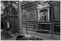 Family in prayer, Sri Mariamman Temple. George Town, Penang, Malaysia ( black and white)