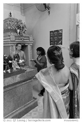 Holy man distributes fire to women, Sri Mariamman Temple. George Town, Penang, Malaysia