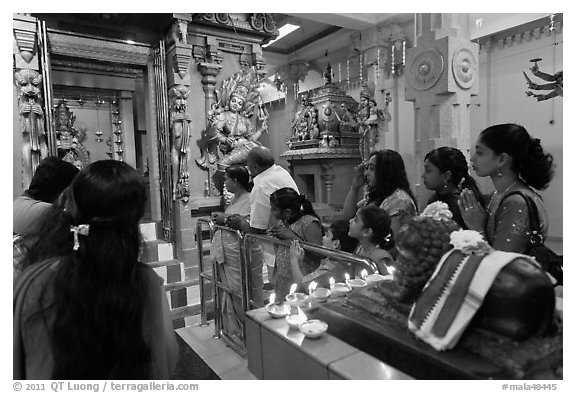 Devotees inside Tamil Nadu temple. George Town, Penang, Malaysia (black and white)