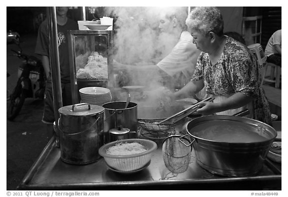Noddles prepared on foodstall by night. George Town, Penang, Malaysia (black and white)