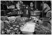 Woman serving dumplings. George Town, Penang, Malaysia (black and white)