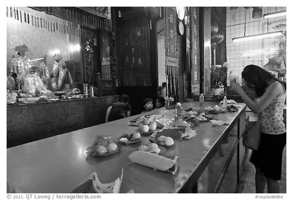 Woman Worshiping inside Chinese temple. George Town, Penang, Malaysia