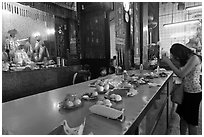 Woman Worshiping inside Chinese temple. George Town, Penang, Malaysia (black and white)