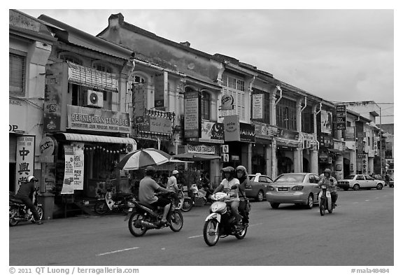 Chinatown street with traffic and storehouses. George Town, Penang, Malaysia (black and white)