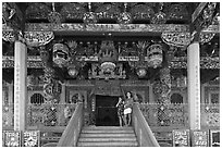 Women standing at Khoo Kongsi entrance. George Town, Penang, Malaysia (black and white)