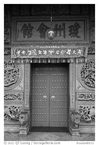Crimson door and slate wall, Hainan Temple. George Town, Penang, Malaysia (black and white)