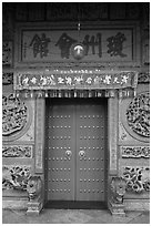 Crimson door and slate wall, Hainan Temple. George Town, Penang, Malaysia (black and white)